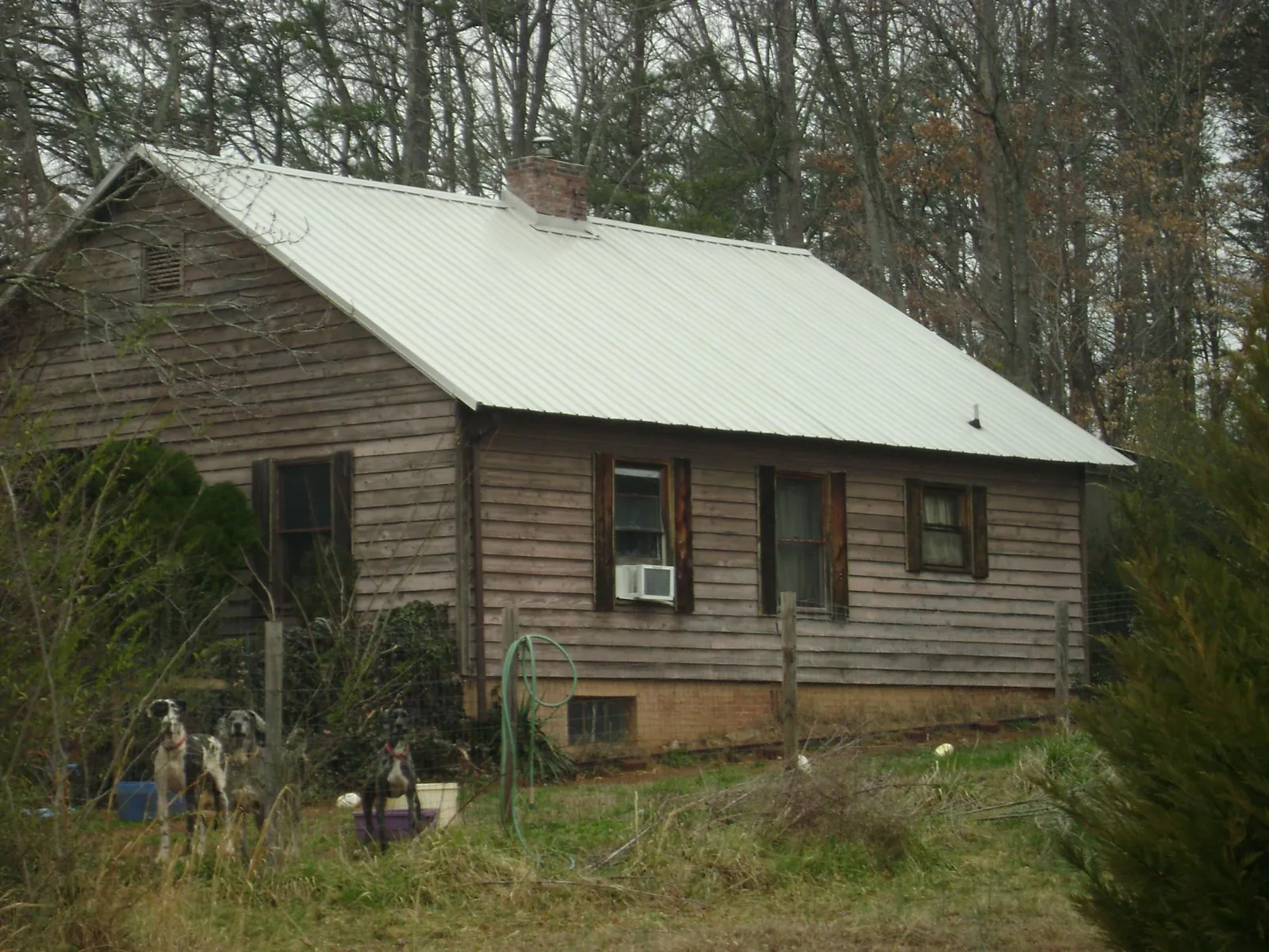 White metal roof on an old wood sided farmhouse, from a Metal Roof Installation job in Islandton